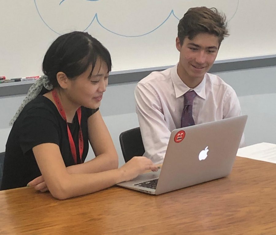 Junior Oscar Low works with Clara in the writing center